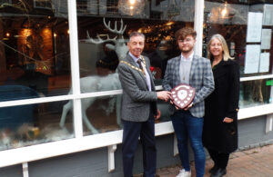 Photo of Mayor Cllr Holbrook with Jane Smith and Operations Manager Luke Kidd standing outside B12 Bar & Kitchen - 2021 winner of the Best Shop Window Christmas Display competition