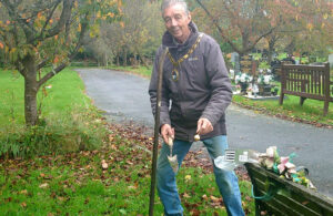 Photo of Mayor Cllr Paul Holbrook planting spring bulbs at Hailsham Cemtery (October 2022)