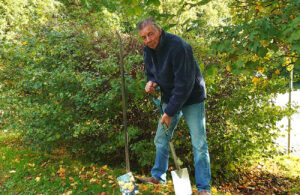 Photo of Mayor Cllr Paul Holbrook planting spring bulbs at Hailsham Country Park (October 2022)