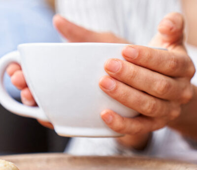 Photo of hands holding hot drink