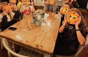 Photo of young people at Friday Night Project HalloweenPottery Glazing Class - October 2023