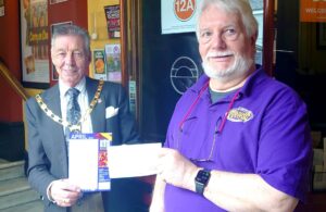 Photo of Mayor Cllr Paul Holbrook presenting donation cheque to Hailsham Festival Chair Tony Biggin