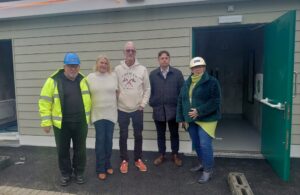 Photo of town councillors and the Town Clerk standing outside the newly installed public toilet facility in Vicarage Field.