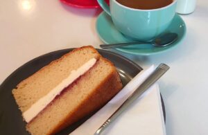 Photo of a slice of cake and a cup of coffee