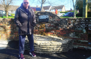 Photo of Pond Warden Phil Hobden standing on the Maryan Alcove at the Common Pond in Bellbanks Road, Hailsham