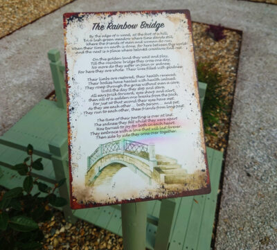 Photo of a sign at Halsham Pet Cemetery displaying the Rainbow Bridge poem on a mounted sign
