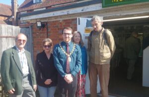 Photo of the Town Mayor Cllr Chris Bryant with museum custodians standing outside the Hailsham Heritage Centre in Blackman's Yard