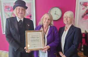 Photo of R. Butler & Sons Funeral Directors receiving the Best Dressed Sussex Day Window Display competition certificate/award